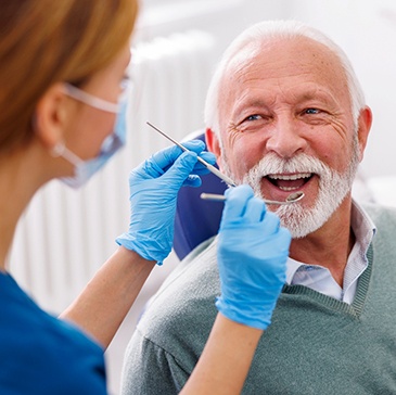 Mature man smiling during dental exam