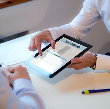 An insurance agent discussing dental insurance with a dental patient