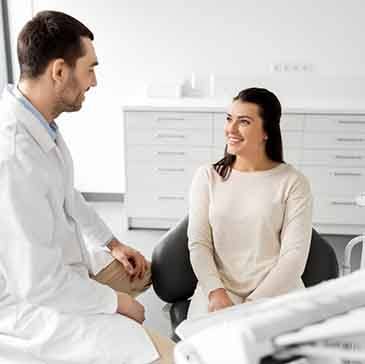 Dentist and patient talking in dental office