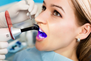 Close up of woman patiently waiting while her dentist examines her teeth